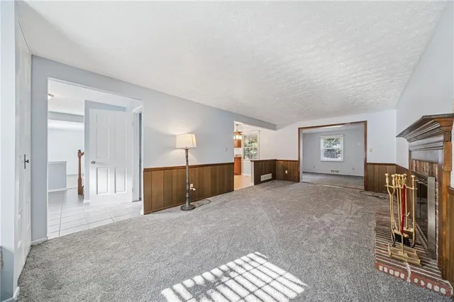 a large bedroom with a bed and a view of living room