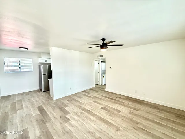a view of a livingroom with a ceiling fan and window