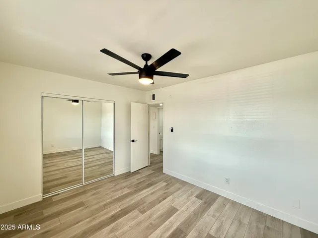 a view of a livingroom with a ceiling fan and window