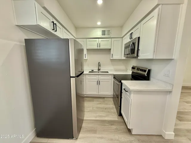 a kitchen with a refrigerator a sink and dishwasher