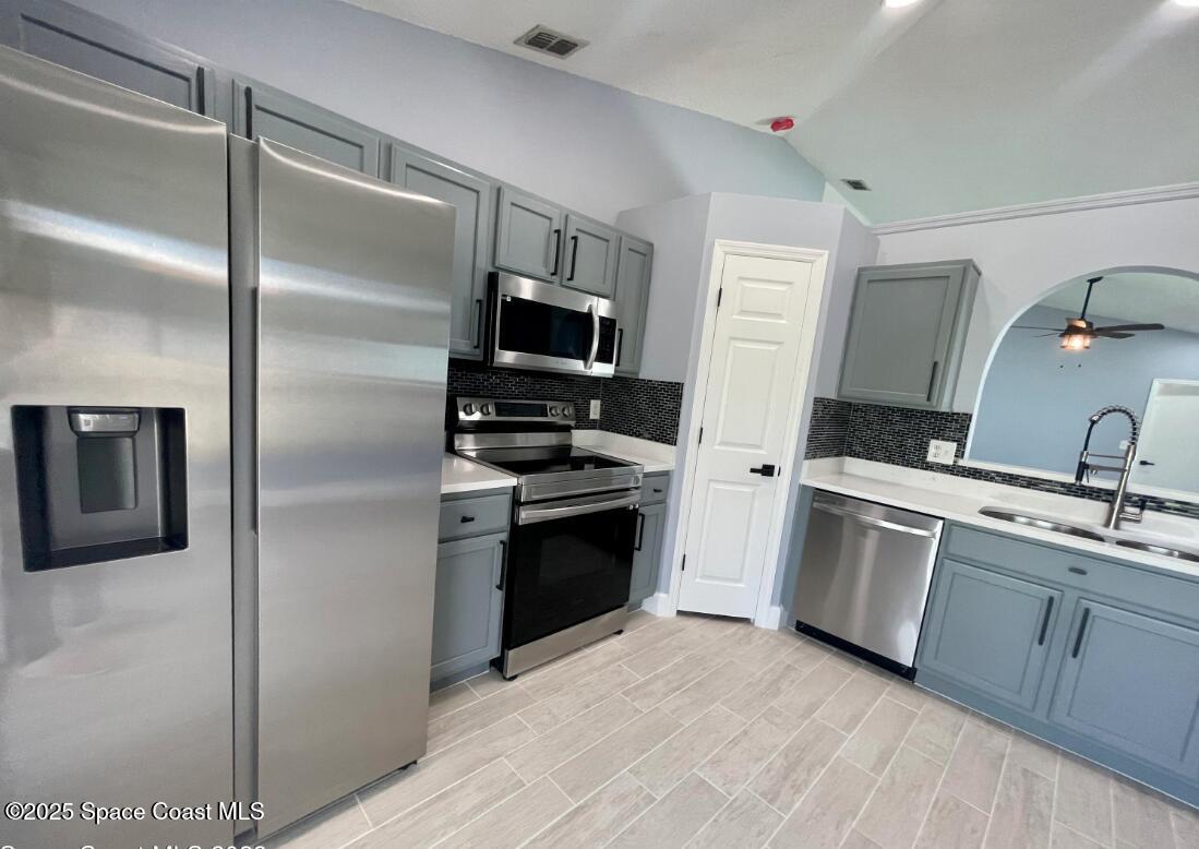 2226 Redwood Circle Palm Bay, FL 32905 - Photo 16 of 27 a kitchen with a refrigerator stove and sink