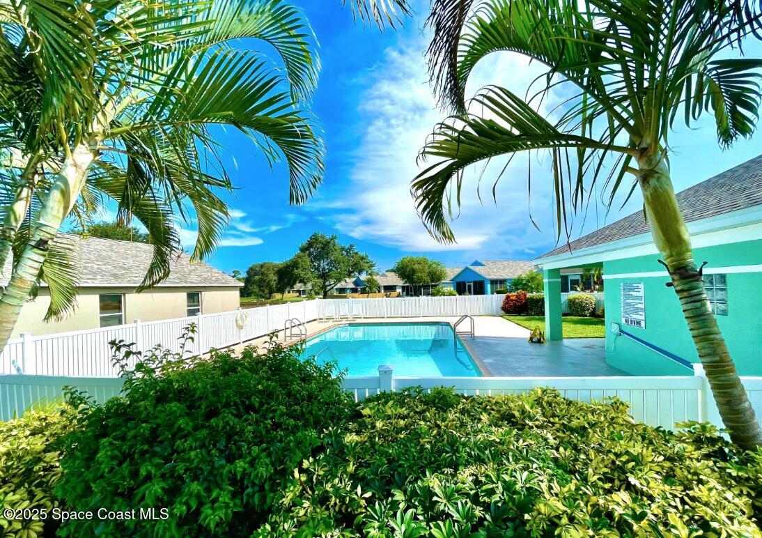 2226 Redwood Circle Palm Bay, FL 32905 - Photo 27 of 27 a view of swimming pool with a garden and trees