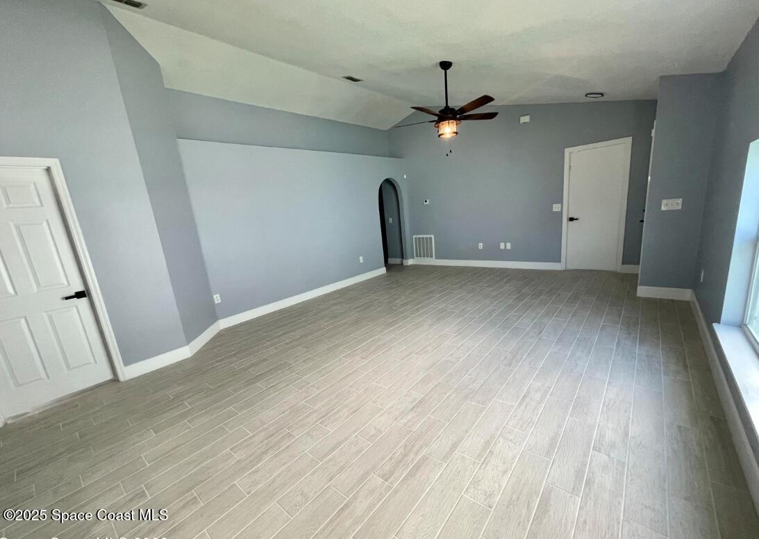 2226 Redwood Circle Palm Bay, FL 32905 - Photo 6 of 27 an empty room with wooden floor and ceiling fan