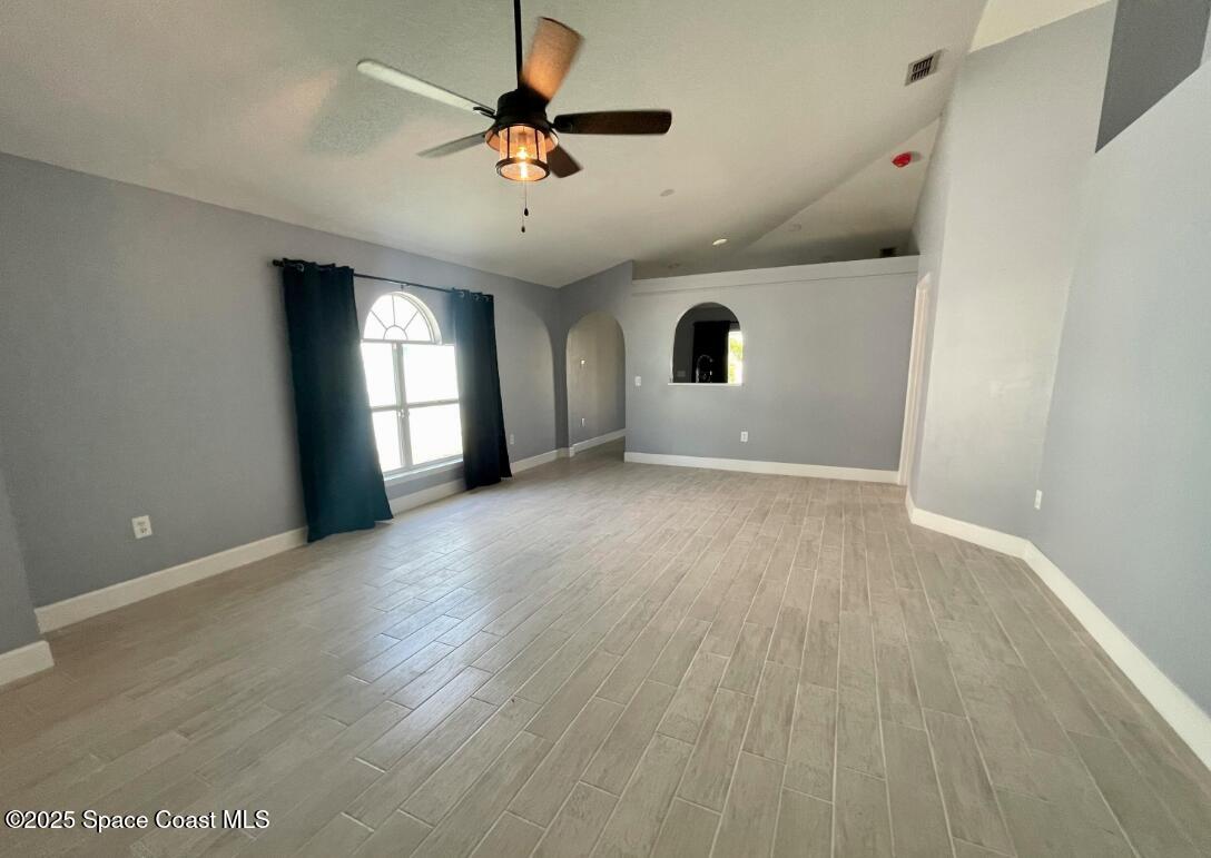 2226 Redwood Circle Palm Bay, FL 32905 - Photo 8 of 27 wooden floor in an empty room with a window