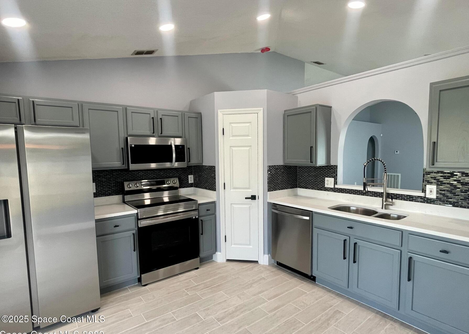 2226 Redwood Circle Palm Bay, FL 32905 - Photo 10 of 27 a kitchen with a sink and stainless steel appliances