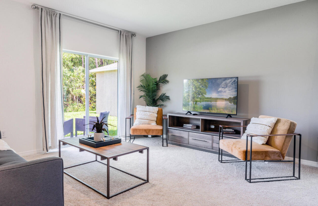 12276 Nettuno Way Port St. Lucie, FL 34987 - Photo 8 of 21 a living room with furniture and a potted plant