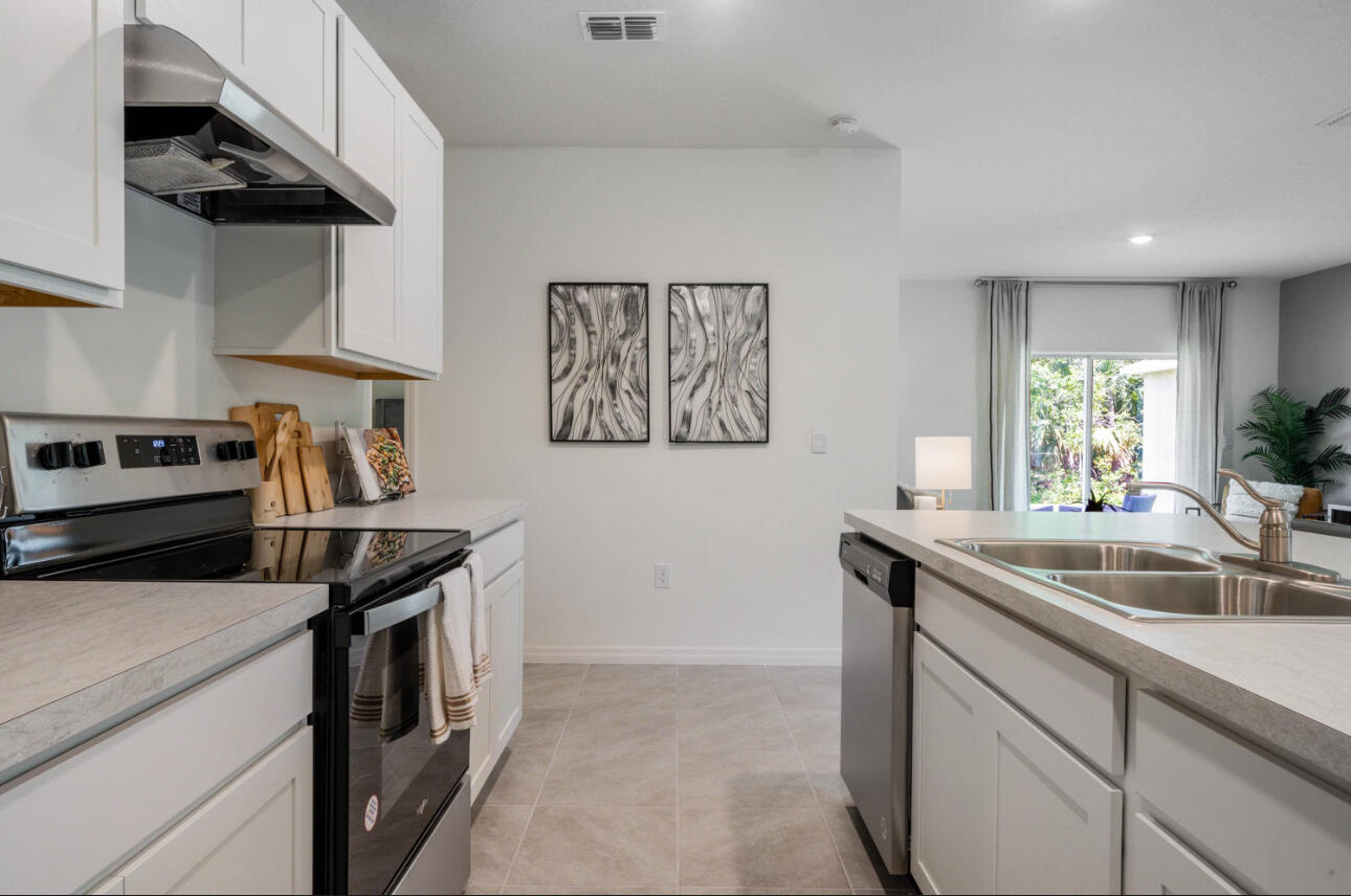 12276 Nettuno Way Port St. Lucie, FL 34987 - Photo 9 of 21 a kitchen that has a sink and a stove