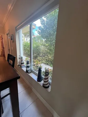 a view of a room with a large window and sitting area