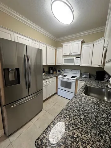 a kitchen with a refrigerator sink and stove