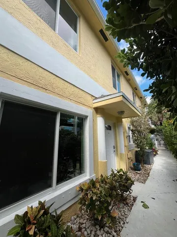 a backyard of a house with barbeque oven table and chairs