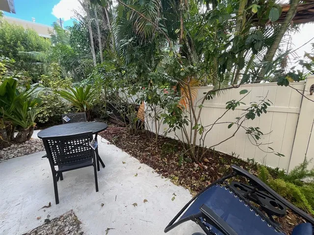 a view of a pathway with flower plants
