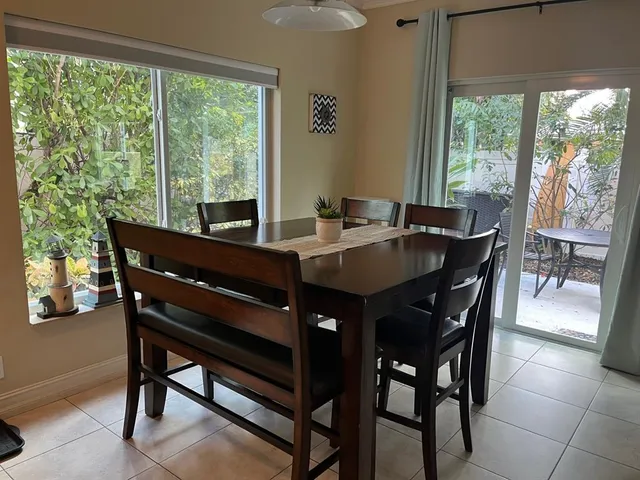 a dining room with a wooden table and chairs
