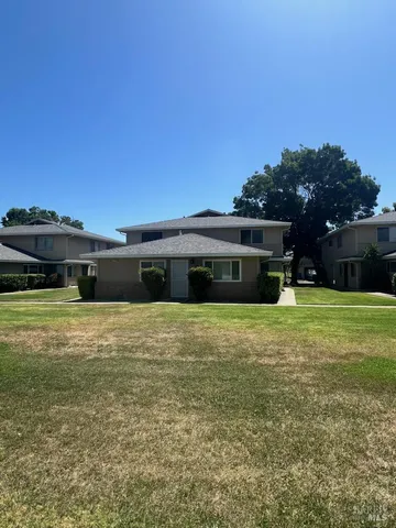 a front view of a house with a garden