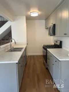 a kitchen with a sink stove and cabinets