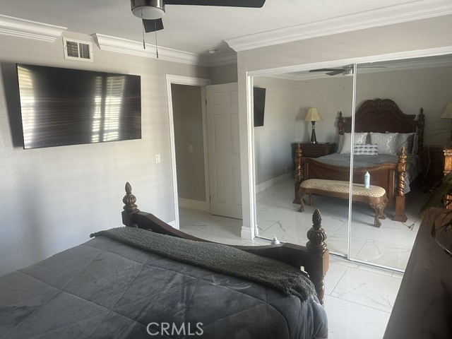 17289 Armintrout Drive Riverside, CA 92504 - Photo 12 of 30 a bedroom with a bed and a mirror