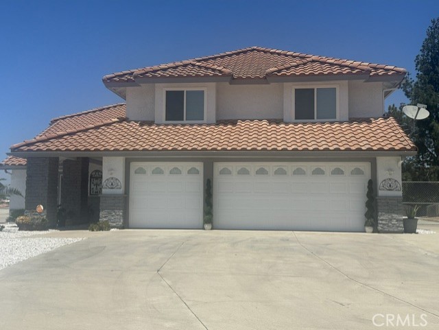 17289 Armintrout Drive Riverside, CA 92504 - Photo 2 of 30 a front view of a house with a yard and garage
