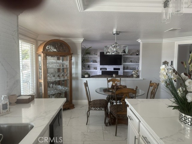 17289 Armintrout Drive Riverside, CA 92504 - Photo 21 of 30 a room with furniture a dining table and a chandelier