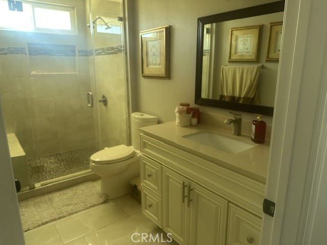 17289 Armintrout Drive Riverside, CA 92504 - Photo 27 of 30 a bathroom with a granite countertop toilet sink and mirror