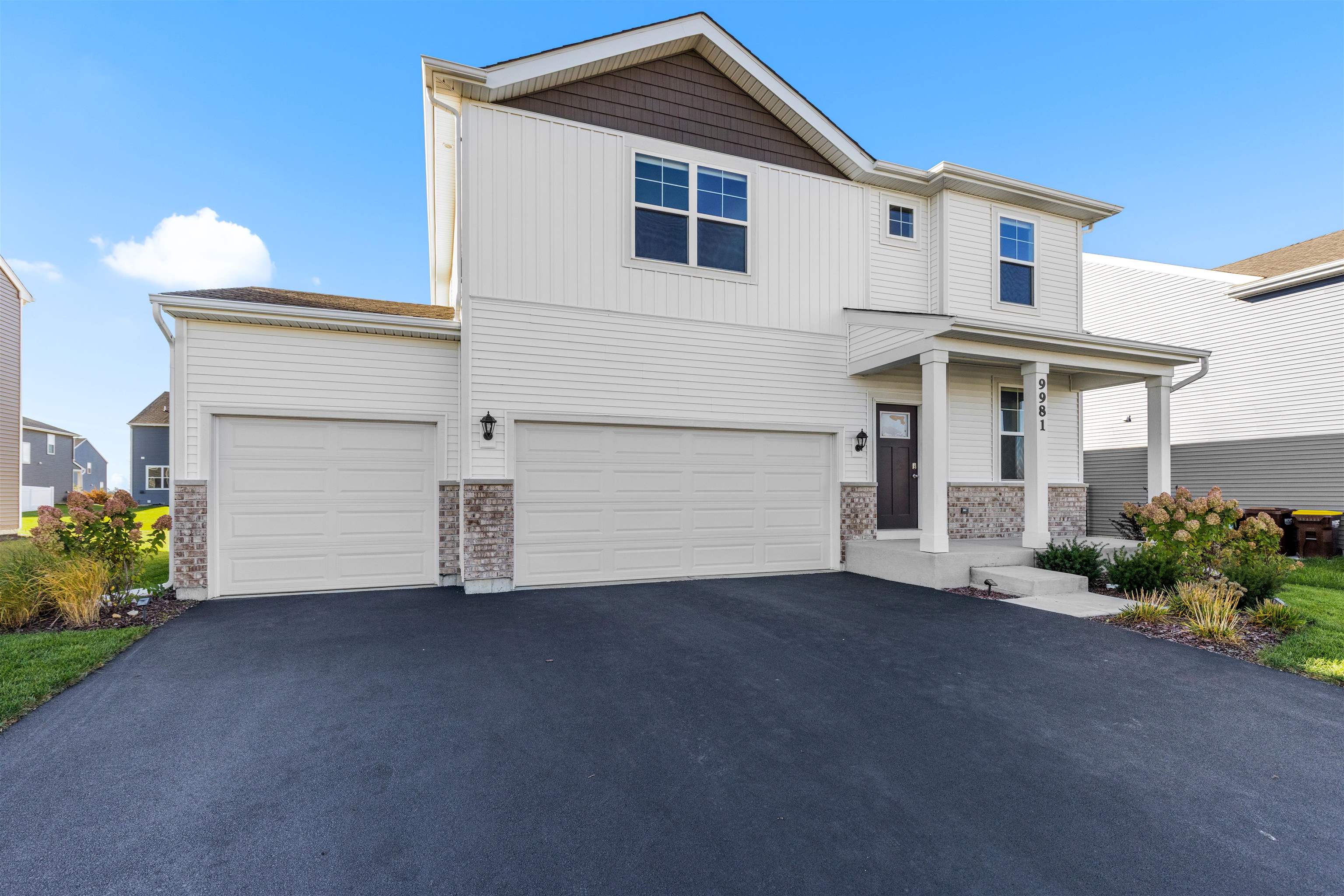9981 Humbolt Avenue Huntley, IL 60142 - Photo 23 of 23 a front view of a house with a yard and garage