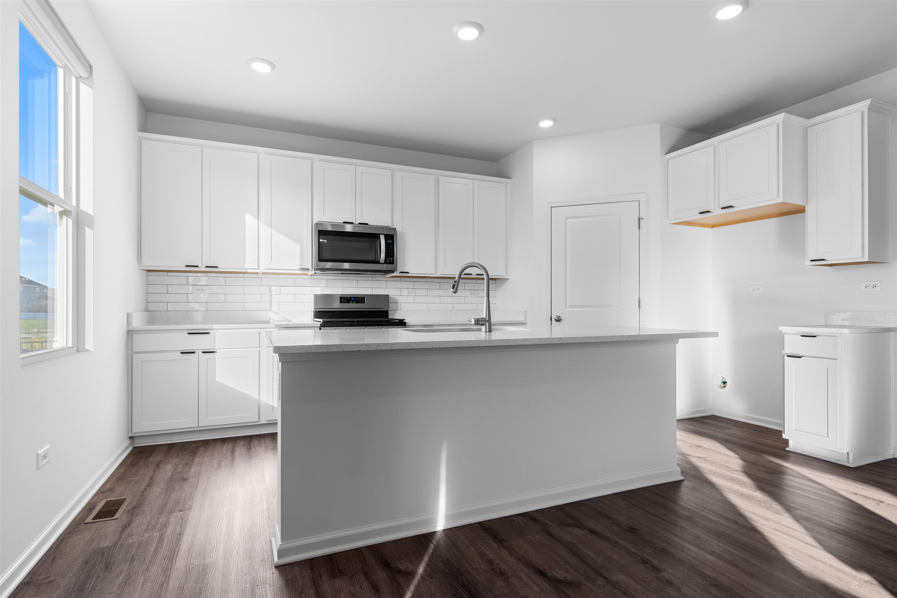 9981 Humbolt Avenue Huntley, IL 60142 - Photo 3 of 23 a kitchen with granite countertop white cabinets and white appliances