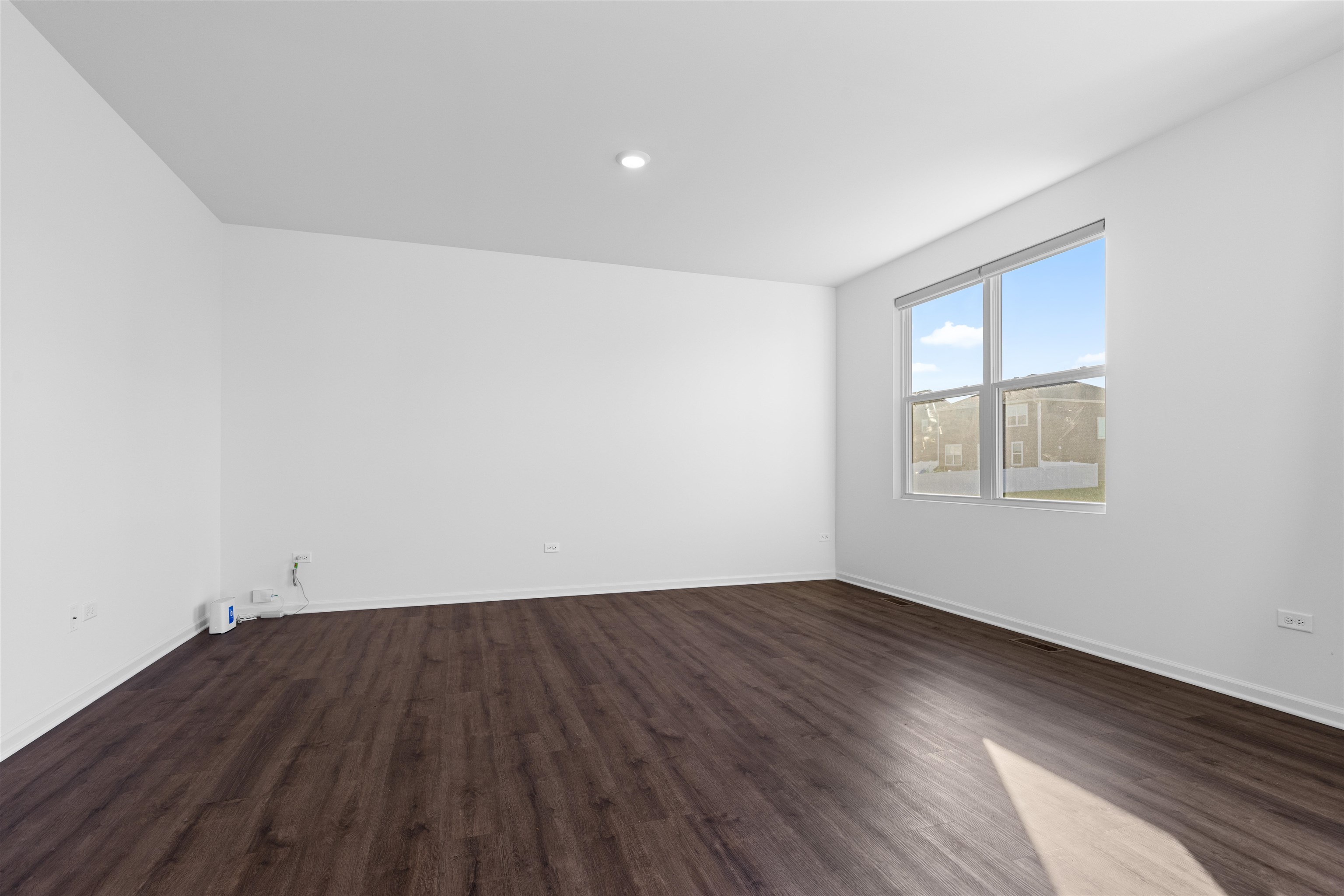 9981 Humbolt Avenue Huntley, IL 60142 - Photo 6 of 23 an empty room with wooden floor and windows