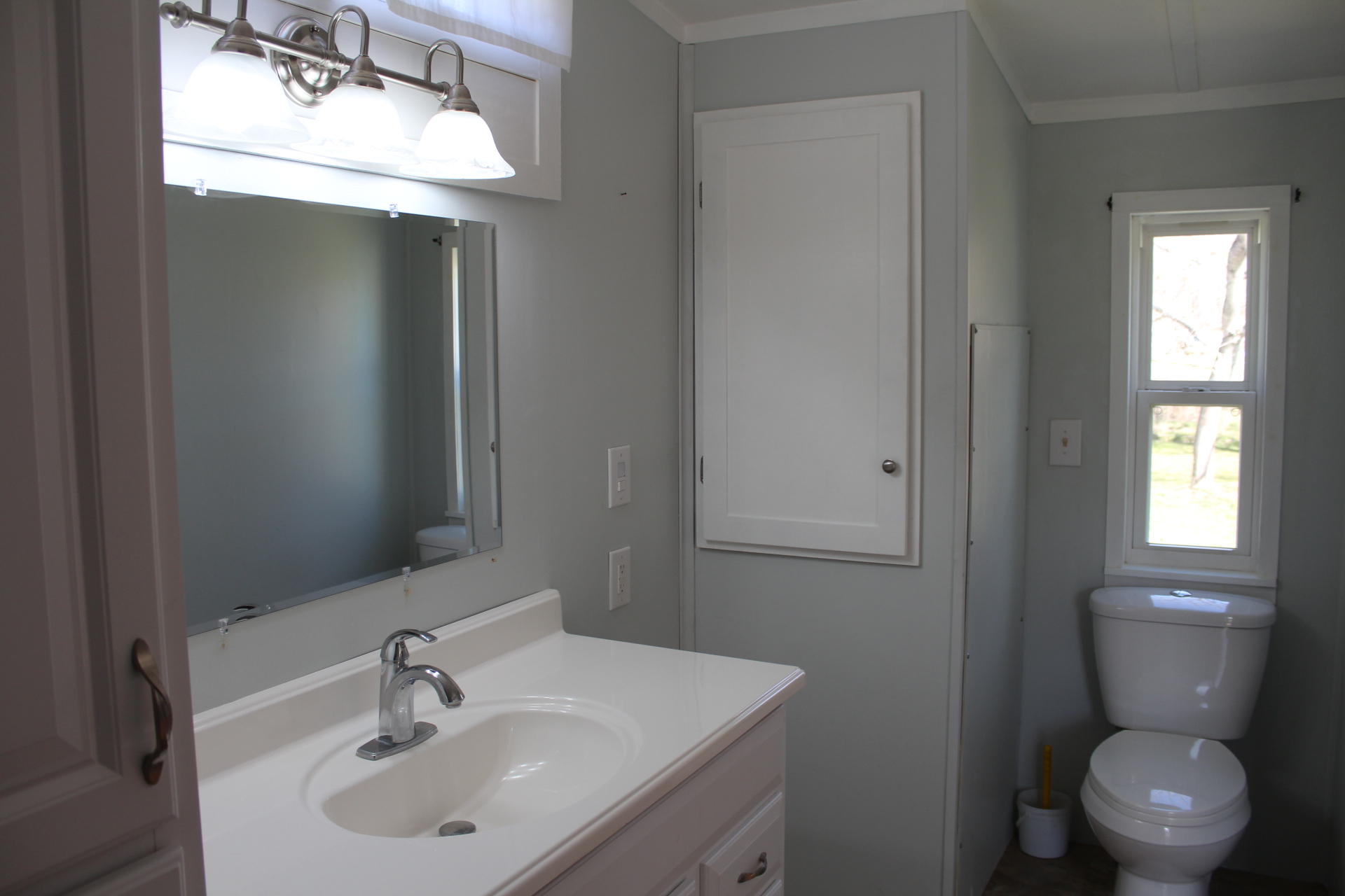1740 Dewbar Road Elliston, VA 24087 - Photo 14 of 28 a bathroom with a toilet sink and mirror