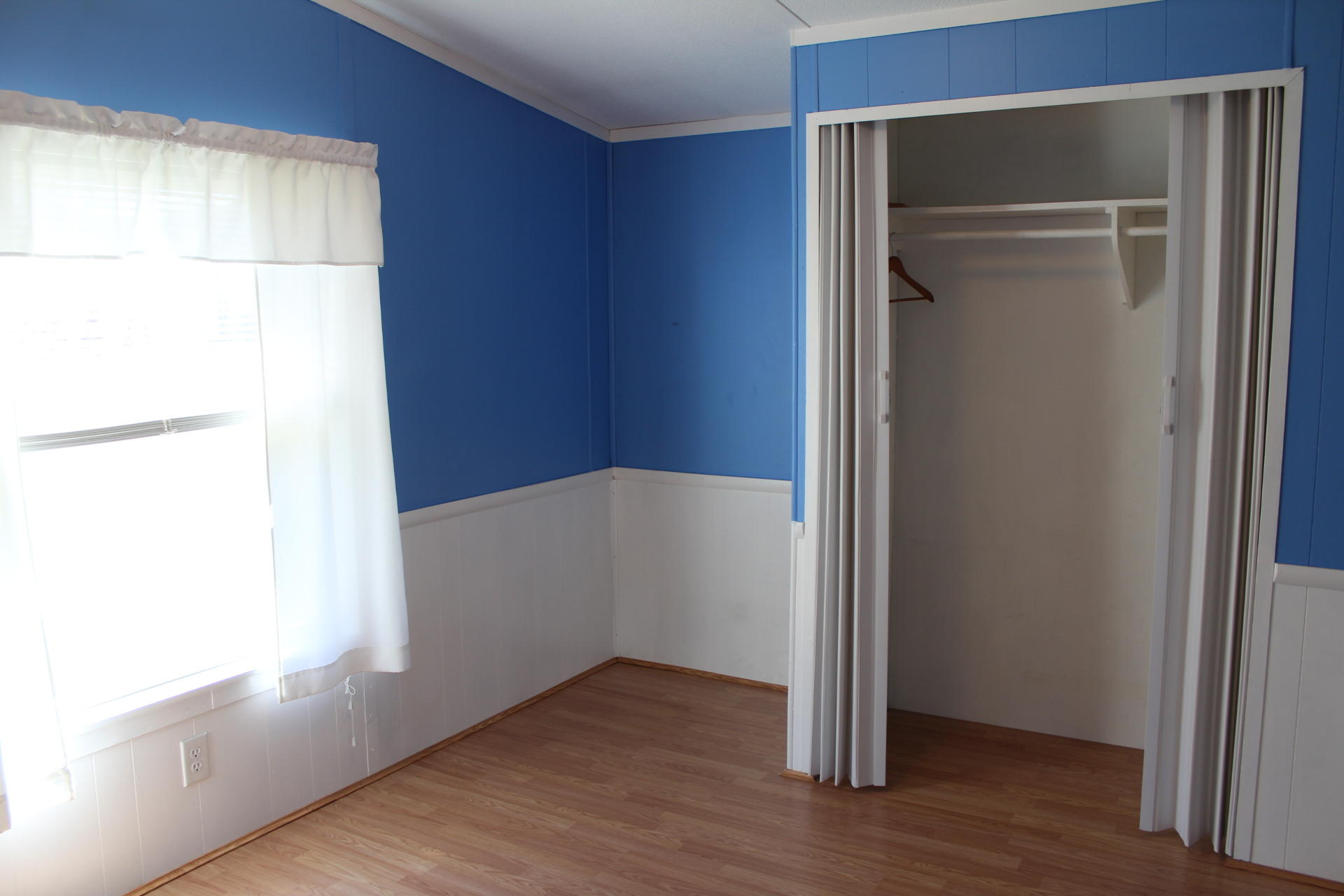 1740 Dewbar Road Elliston, VA 24087 - Photo 22 of 28 an empty room with wooden floor closet and windows