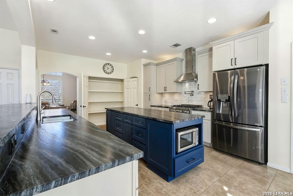 318 River Ridge Boerne, TX 78006 - Photo 16 of 46 a kitchen with stainless steel appliances granite countertop a refrigerator a stove and a sink
