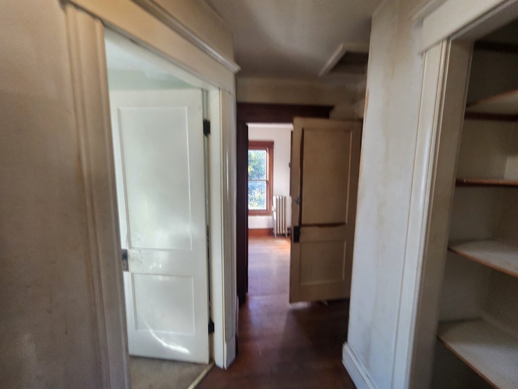 18 Brunswick Street Springfield, MA 01108 - Photo 12 of 23 a view of a hallway with wooden floor