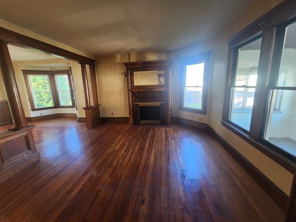 18 Brunswick Street Springfield, MA 01108 - Photo 14 of 23 wooden floor fireplace and windows in an empty room