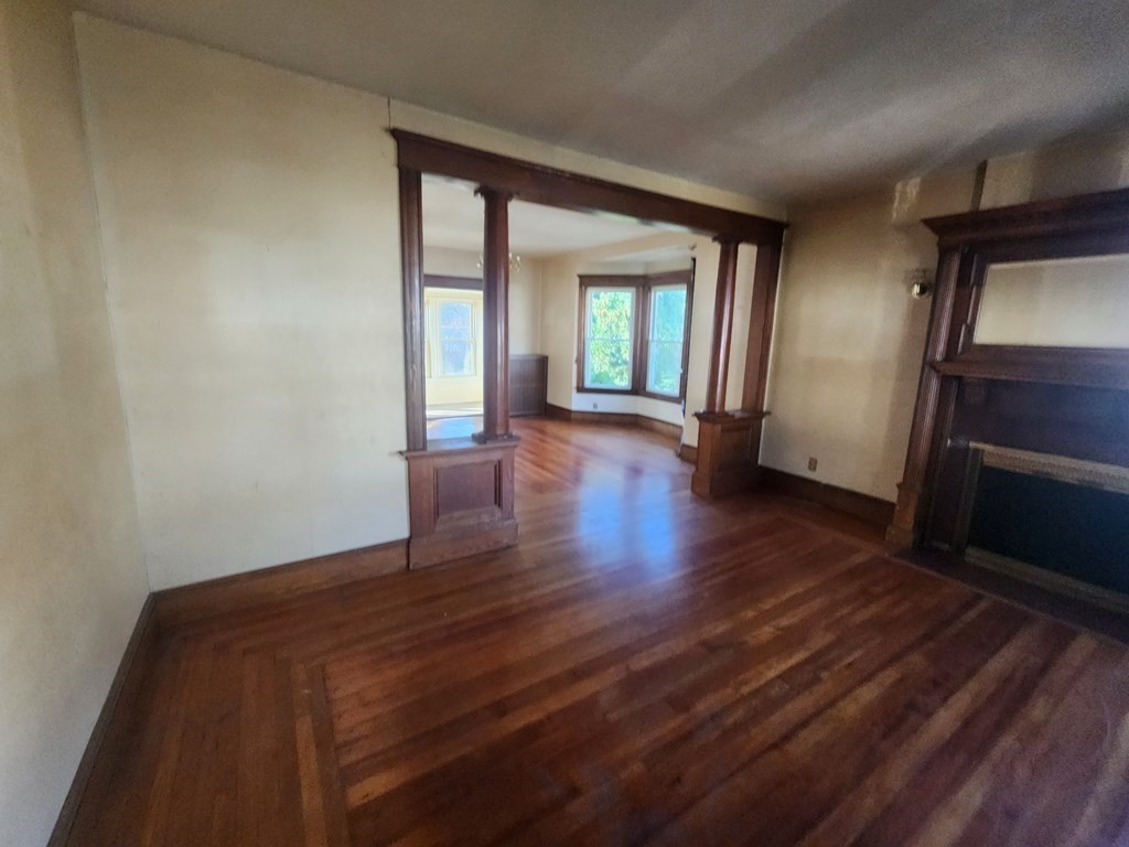 18 Brunswick Street Springfield, MA 01108 - Photo 15 of 23 a view of an empty room with wooden floor and a window
