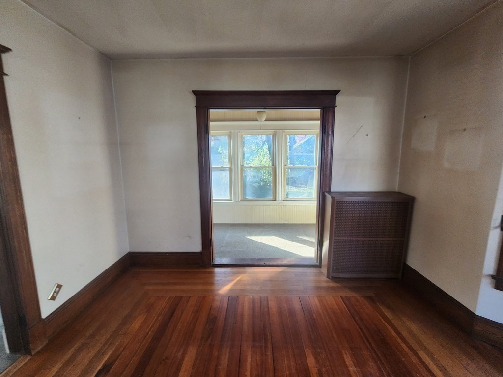 18 Brunswick Street Springfield, MA 01108 - Photo 16 of 23 a view of empty room with wooden floor and fan