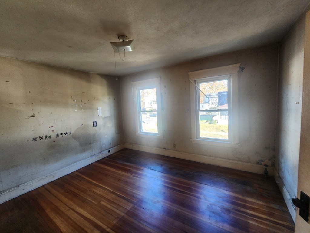 18 Brunswick Street Springfield, MA 01108 - Photo 17 of 23 an empty room with wooden floor and windows