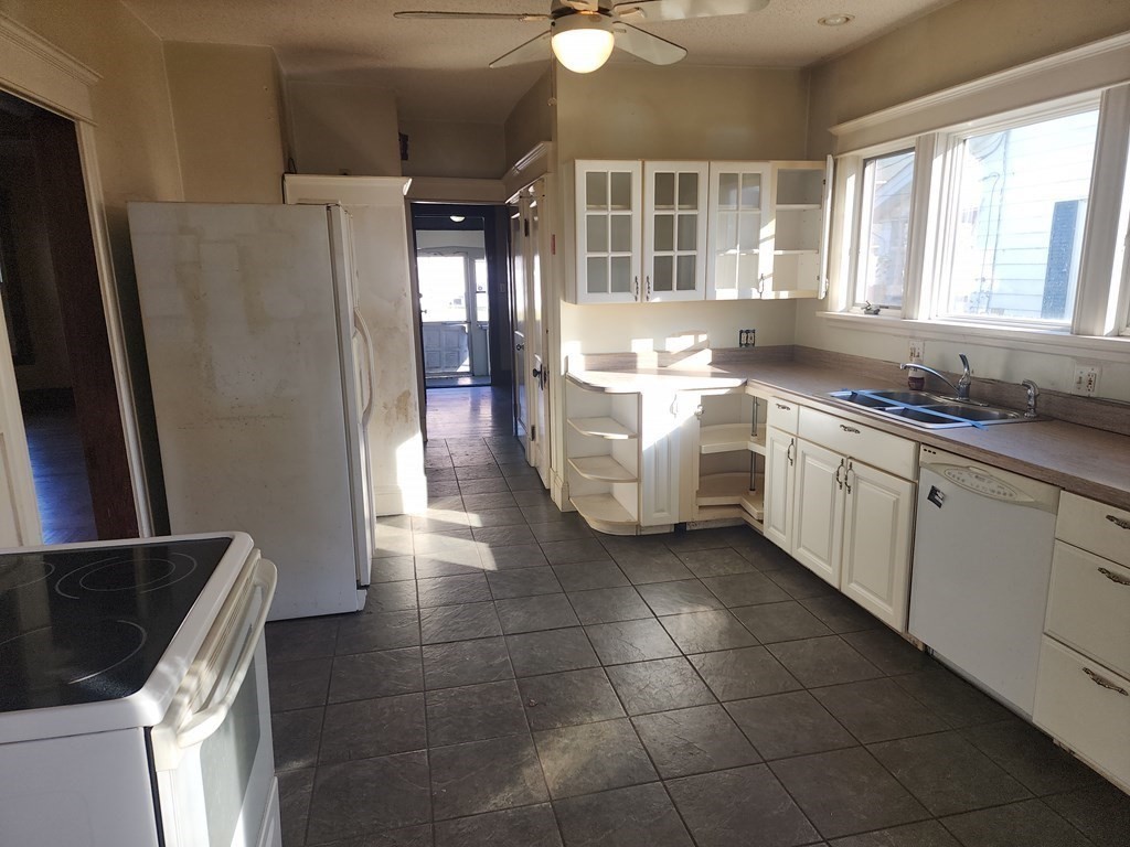 18 Brunswick Street Springfield, MA 01108 - Photo 6 of 23 a kitchen with a stove a refrigerator and a sink