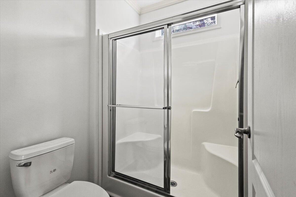 805 Ave B Fort Pierce, FL 34950 - Photo 13 of 29 a bathroom with a shower a toilet and a glass door