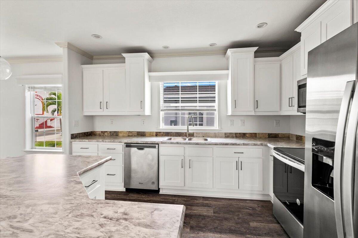 805 Ave B Fort Pierce, FL 34950 - Photo 16 of 29 a kitchen with stainless steel appliances granite countertop a stove a sink and a refrigerator
