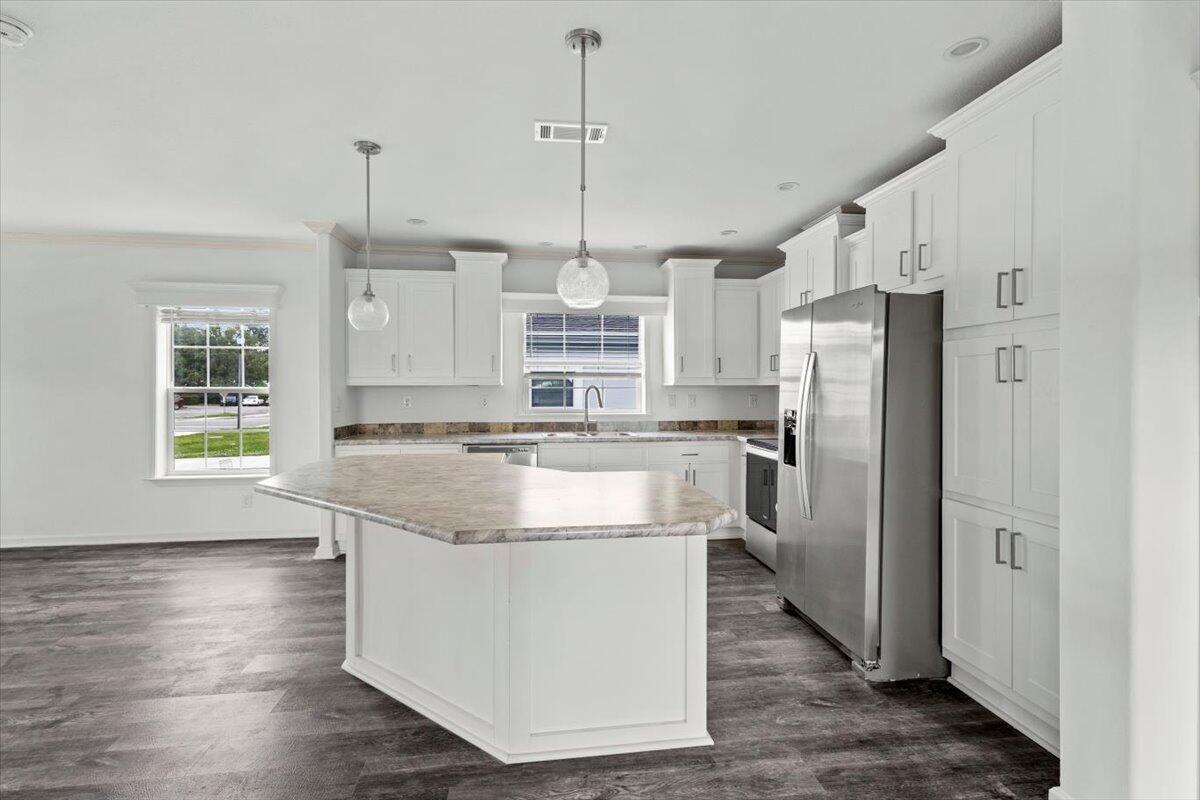 805 Ave B Fort Pierce, FL 34950 - Photo 17 of 29 a kitchen with stainless steel appliances granite countertop a refrigerator a oven a sink and a chandelier