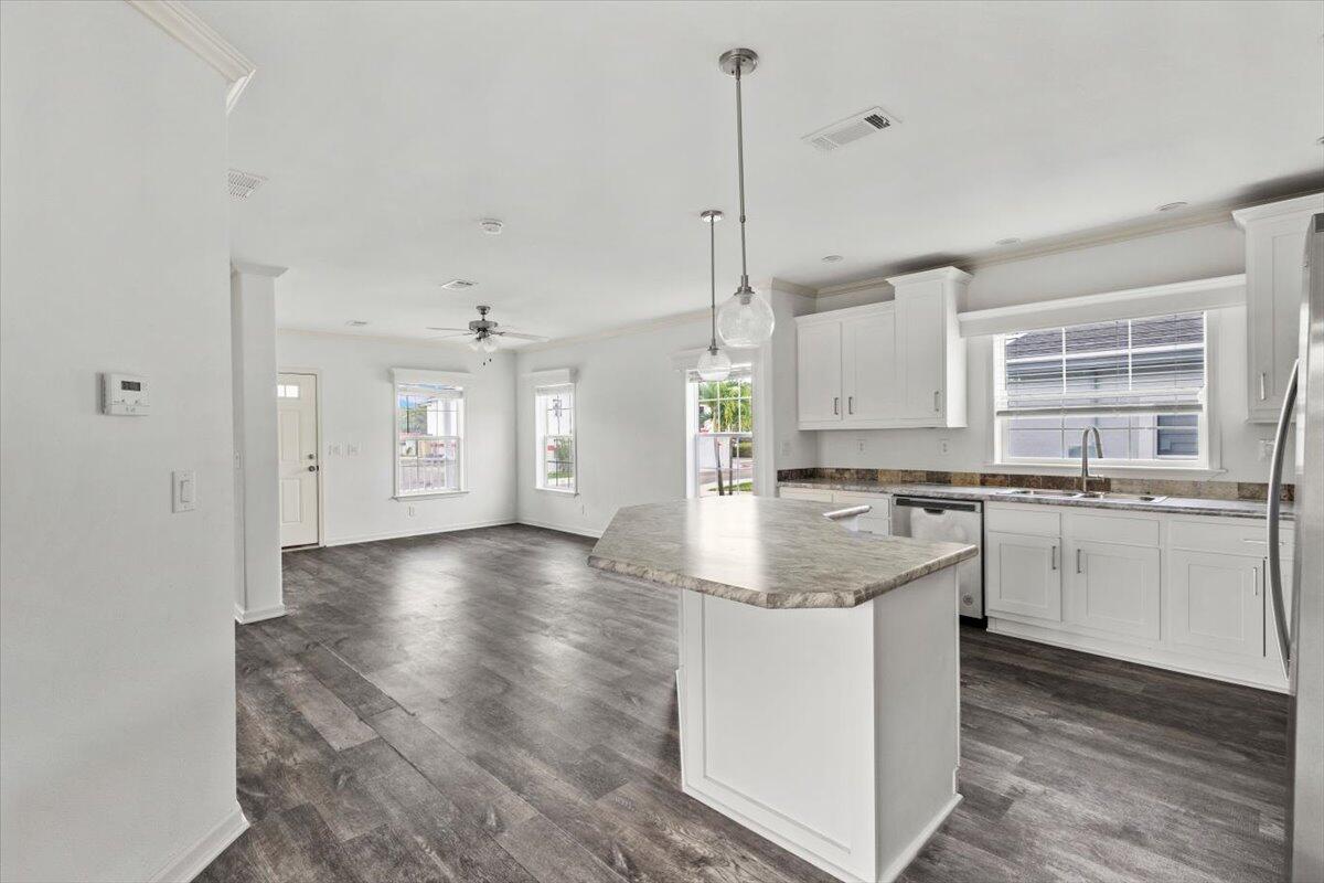 805 Ave B Fort Pierce, FL 34950 - Photo 18 of 29 a kitchen with stainless steel appliances granite countertop a sink a stove and a window
