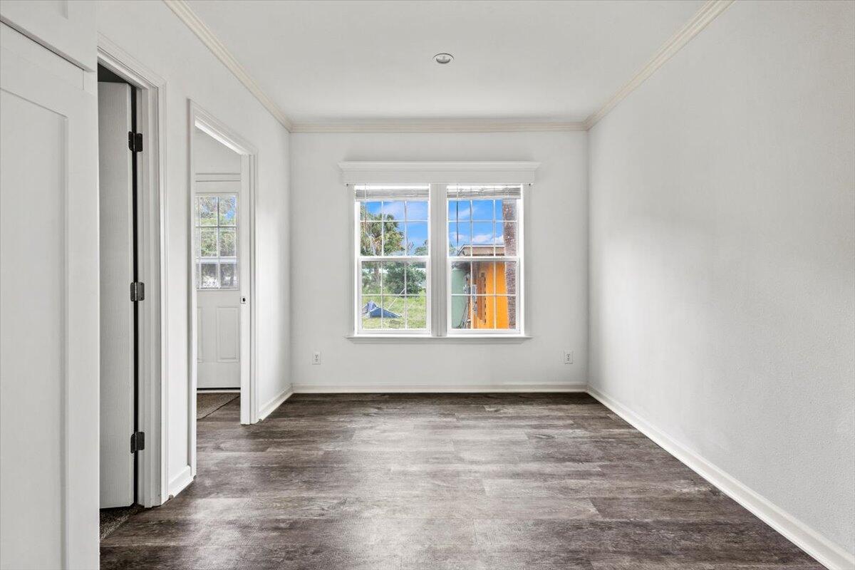 805 Ave B Fort Pierce, FL 34950 - Photo 19 of 29 an empty room with wooden floor and windows