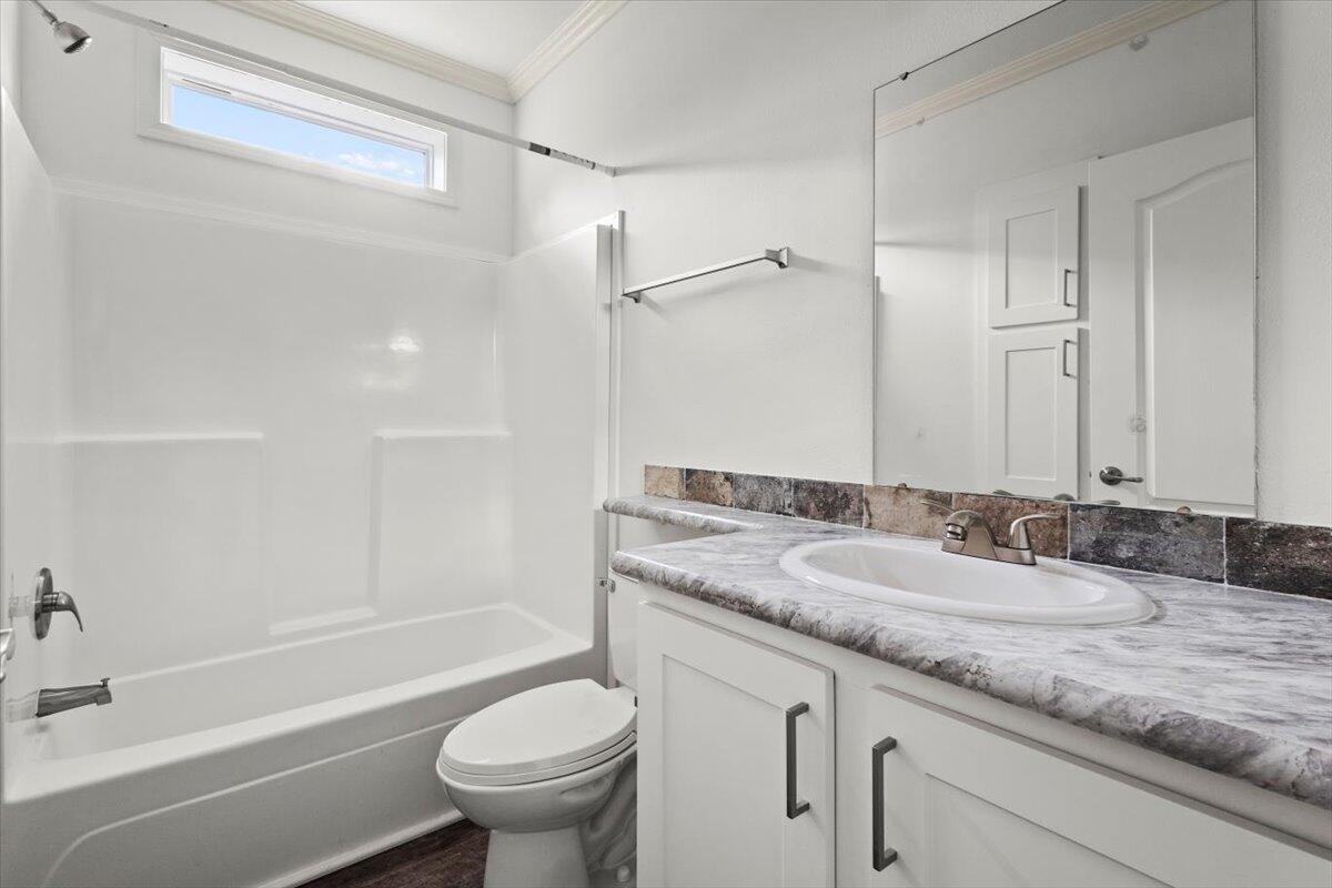 805 Ave B Fort Pierce, FL 34950 - Photo 22 of 29 a bathroom with a granite countertop sink a toilet and a bathtub