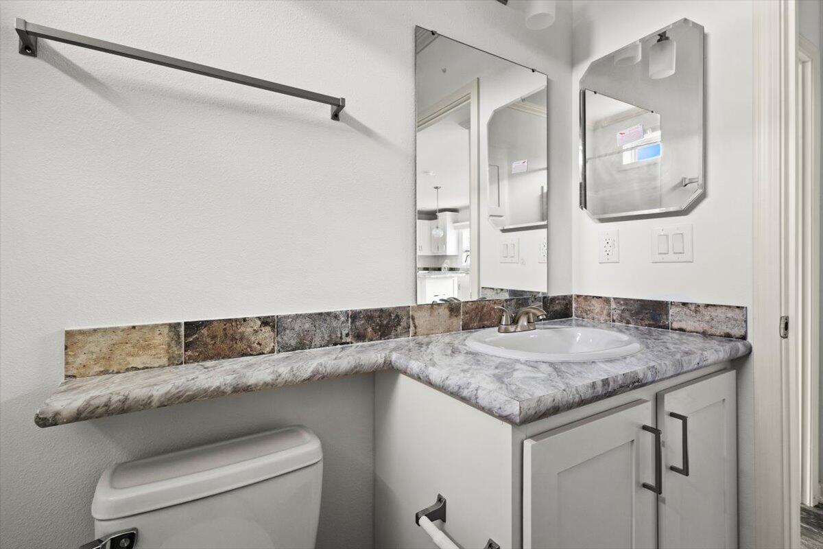 805 Ave B Fort Pierce, FL 34950 - Photo 23 of 29 a bathroom with a granite countertop sink and a mirror
