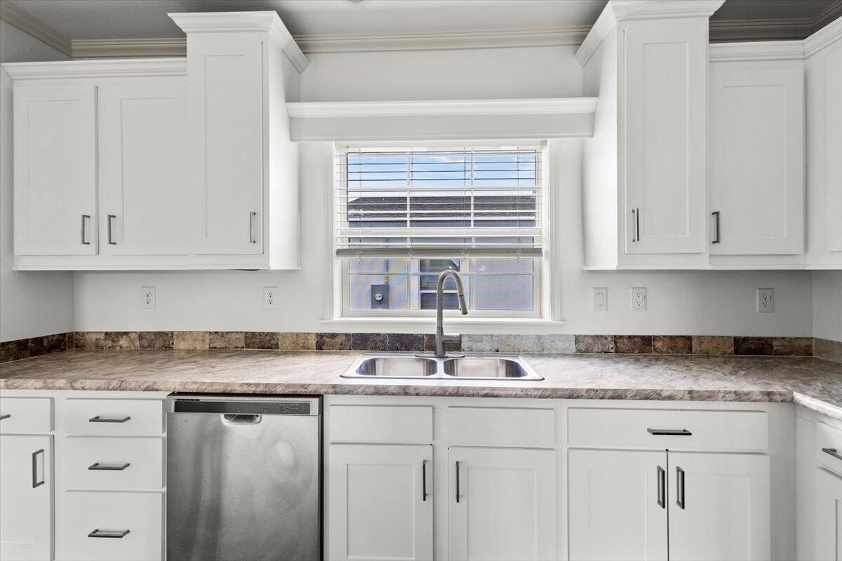 805 Ave B Fort Pierce, FL 34950 - Photo 6 of 29 a kitchen with granite countertop white cabinets and a sink