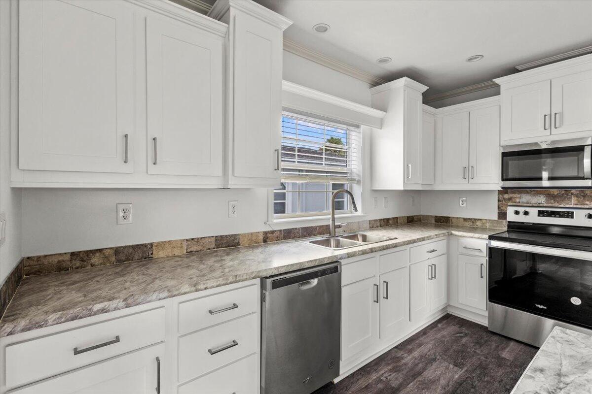 805 Ave B Fort Pierce, FL 34950 - Photo 7 of 29 a kitchen with appliances cabinets and a sink