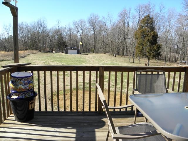 417 Blackey Bandy Road Bethpage, TN 37022 - Photo 18 of 20 12x12 deck overlooks level backyard and woods at the back of property.