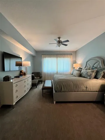 a bedroom with bed couch and window