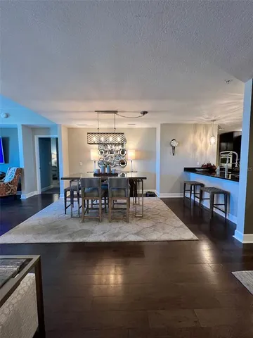 a kitchen with dining room and chandelier