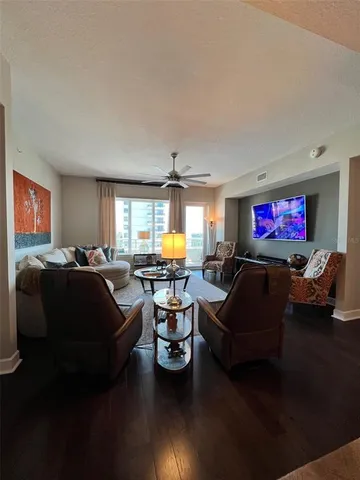 a living room with furniture window and wooden floor