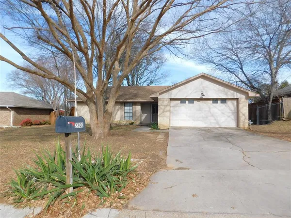 a view of a house with a yard and garage