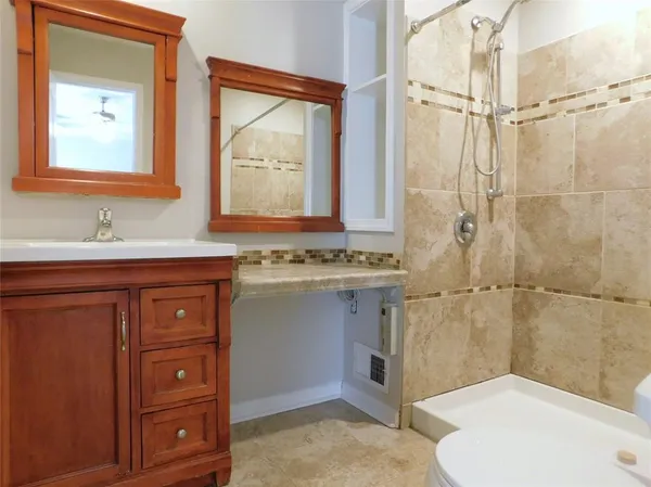 a bathroom with a sink a toilet and shower