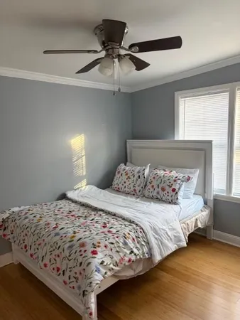 a bedroom with a bed and window